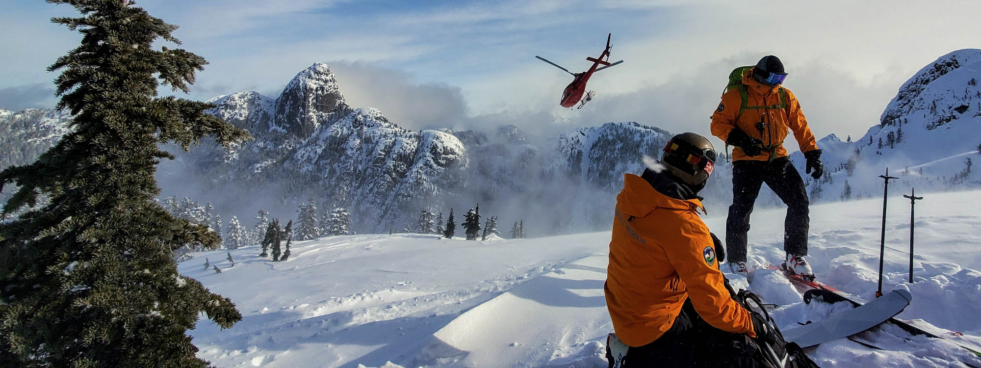 Squamish SAR members dropped off by helicopter on a snowy peak